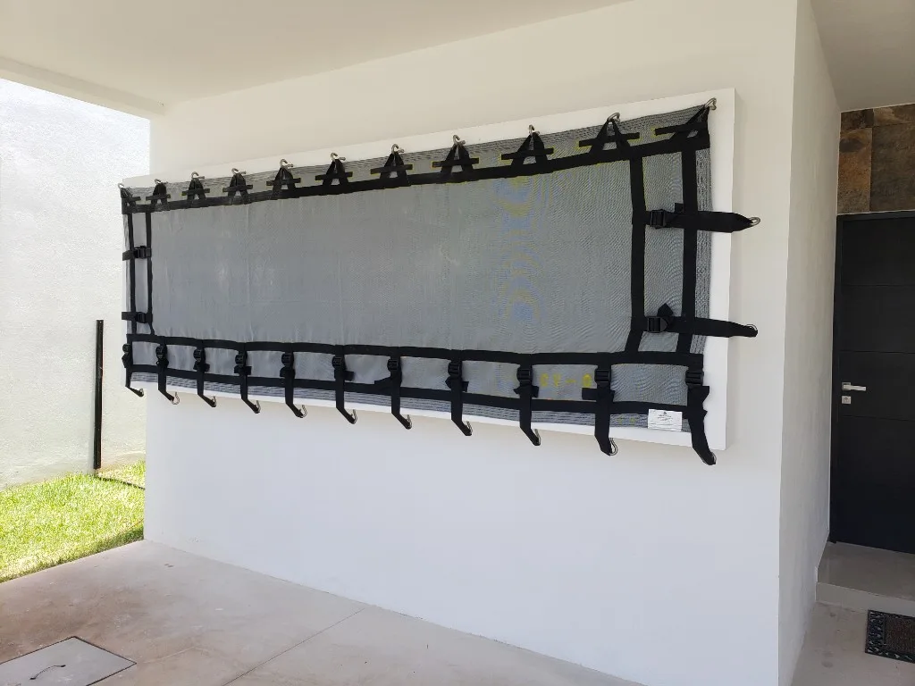 White storm screen under wooden patio beams